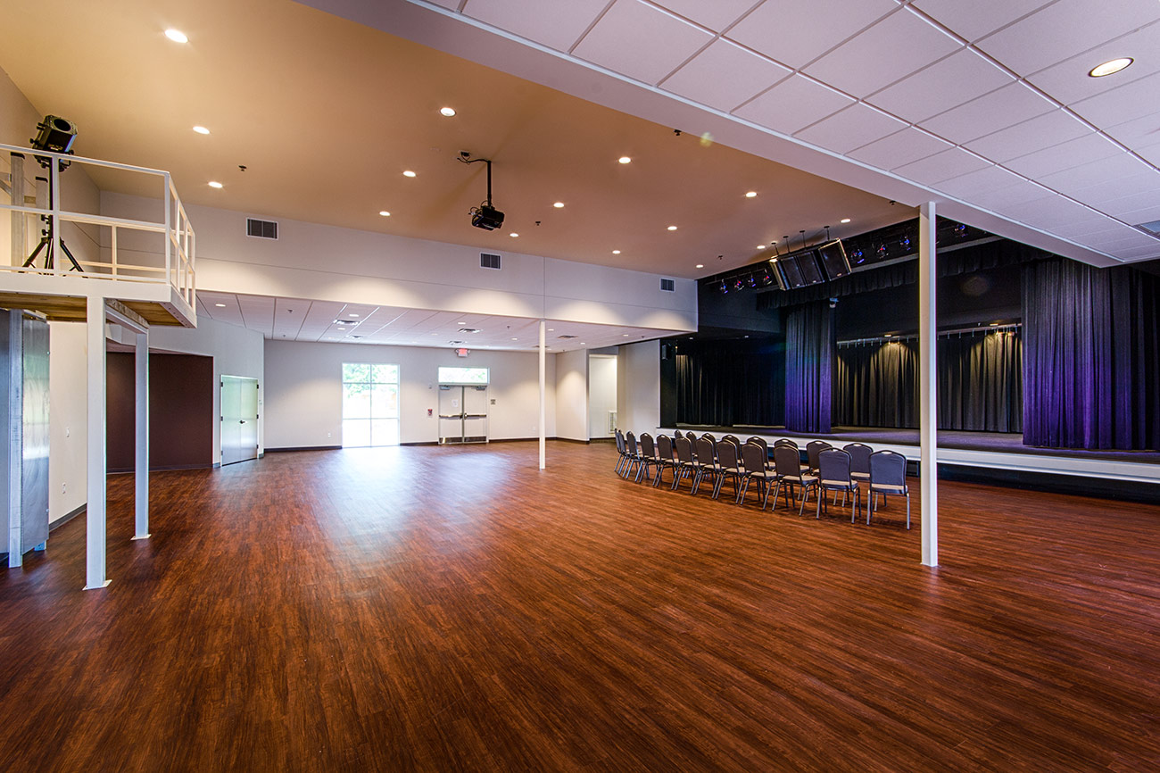 A large auditorium with raised stage in the Leland Cultural Arts Center