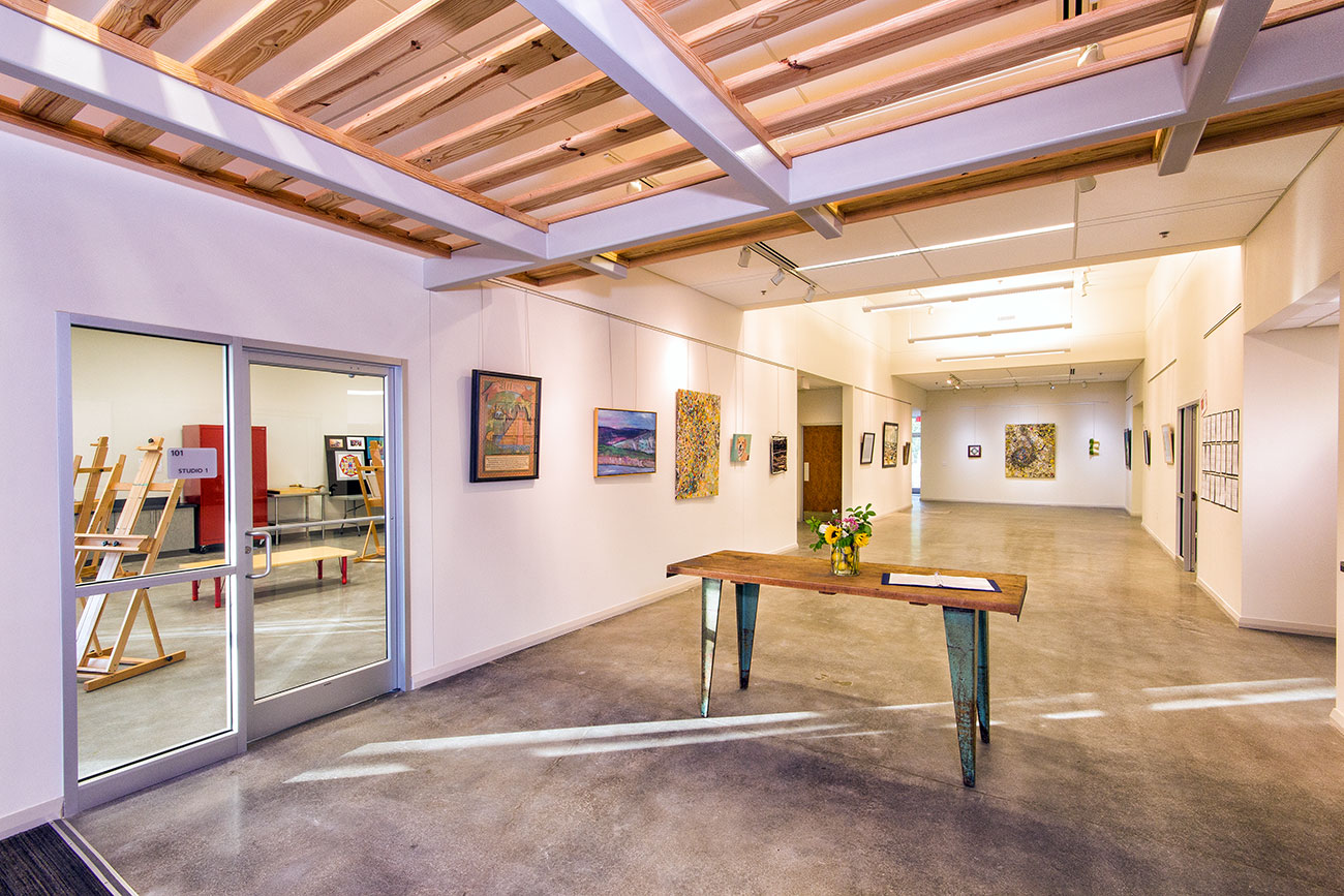 A concrete-floored interior hallway in the Leland Cultural Arts Center